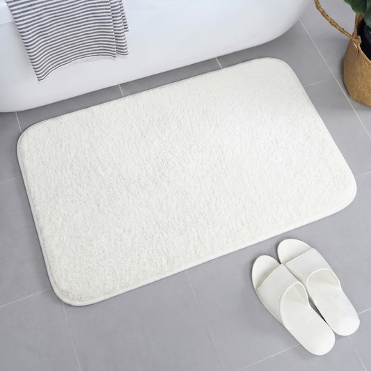 White plush bathroom mat with rounded corners on bathroom floor