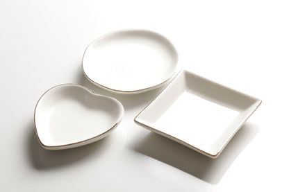 White ceramic trinket dishes in heart, square, and round shapes with gold rim